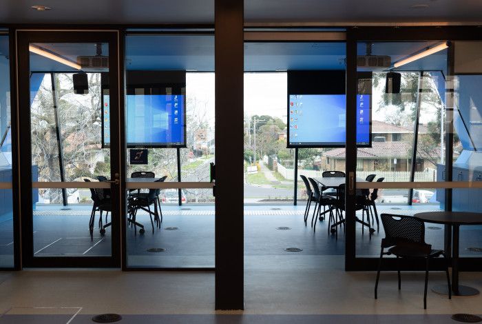 Image: View of a meeting room in the library with desks and screens