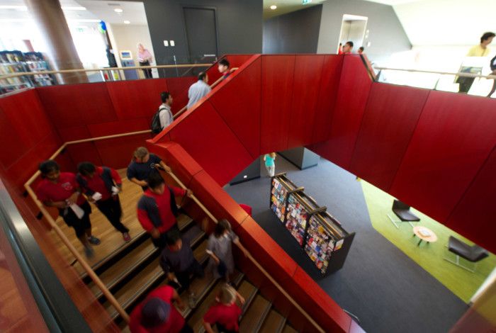 Image: A group of school children exploring the library