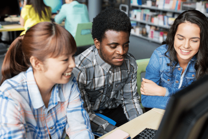 Image: a group of youths gathered at the library