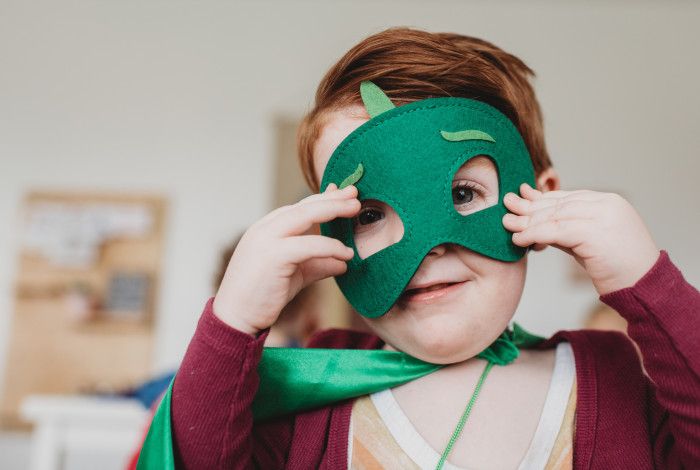 Image: a child wearing a green mask on his eyes