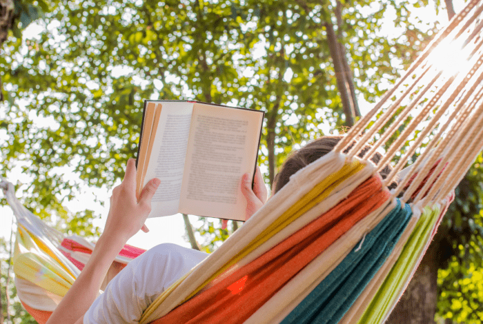 Woman in a hammock reading a book