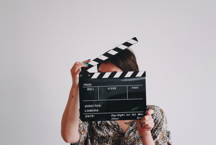 A person holding a clapperboard