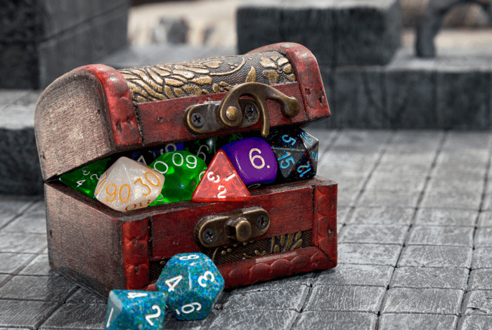 A treasure chest filled with various shaped dice