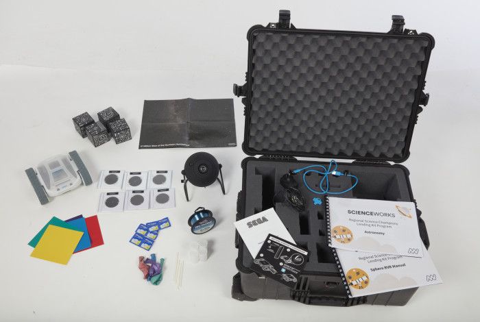 An open astronomy kit with contents beside it.