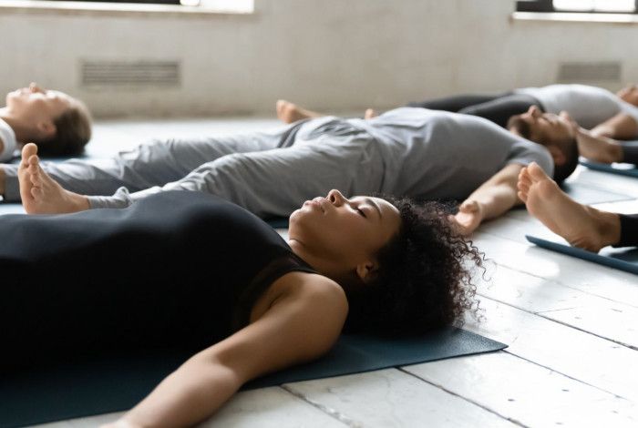 People lying on the floor for Yoga.