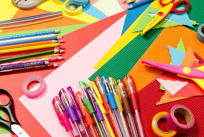 Colourful stationery including pens, pencils, scissors and tape.