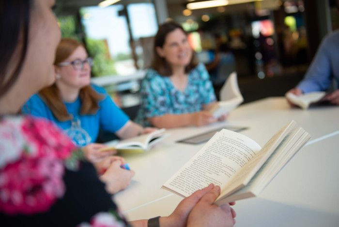 Close up of hands holding a book.