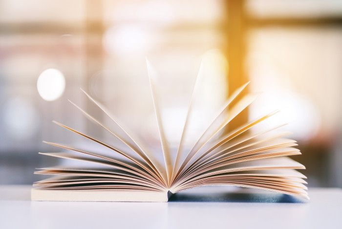 Book opened on a table with pages open.