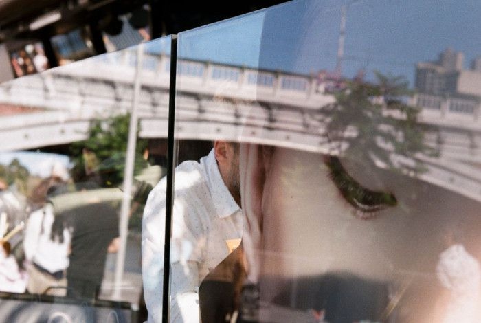 Woman's face reflected in restaurant window.