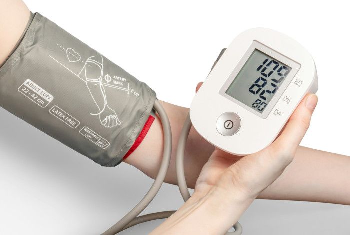 A person using a blood pressure monitor.