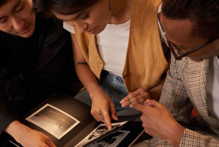 Family members browsing through a photo album. 