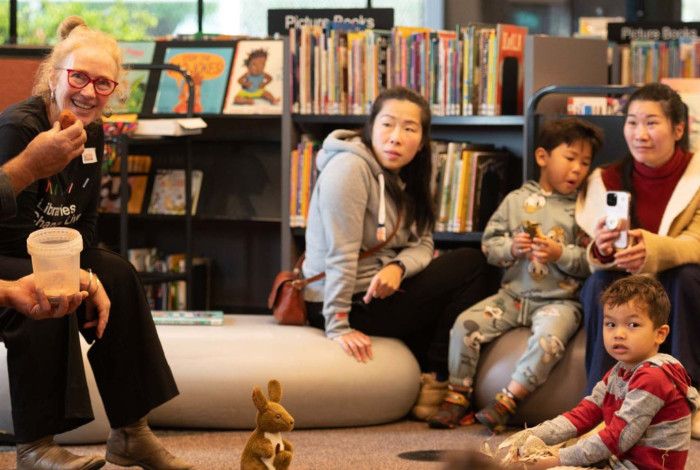 A family enjoying an indigenous themed storytime at the library.