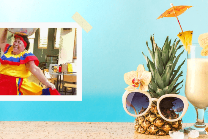 Postcard portraying a Columbian woman with items on a table including a pineapple, coconut, shells and a cocktail.