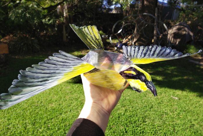 Bird puppet being held aloft.