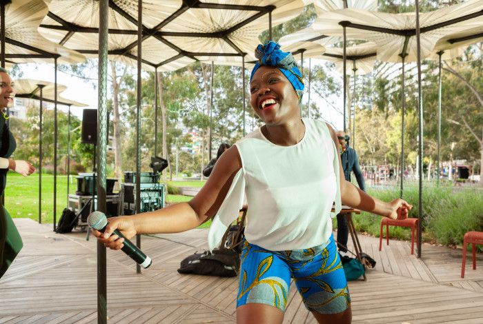 Kwabo dancer on stage with microphone. 