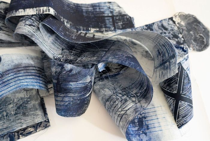 Printed reels holding inked reproductions from linocuts.