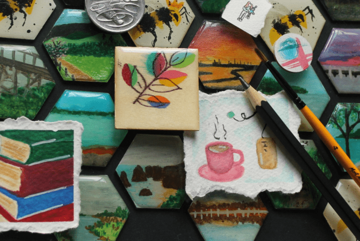 A display of small mixed media artworks - miniature paintings, drawings and collages.