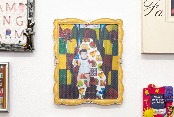 Differently styled photo frames hanging up on a white wall.