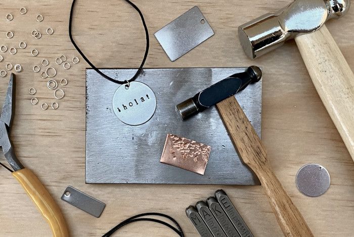 Metal working tools displayed on a wooden table.