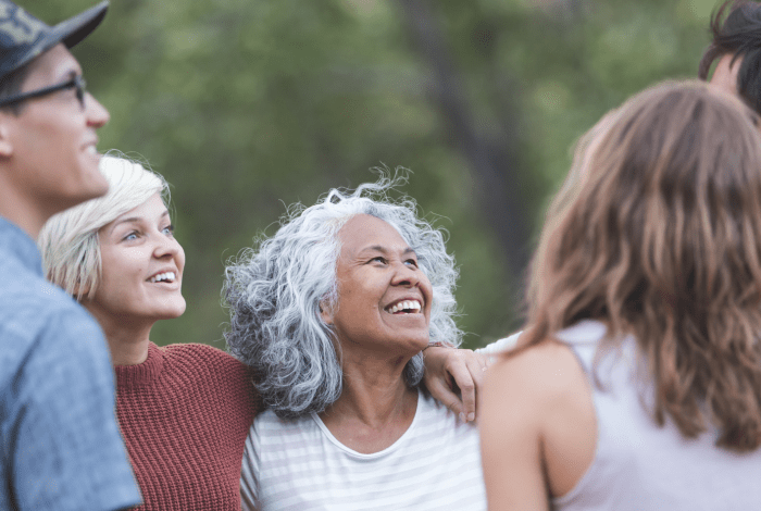 A group of people standing looking happy