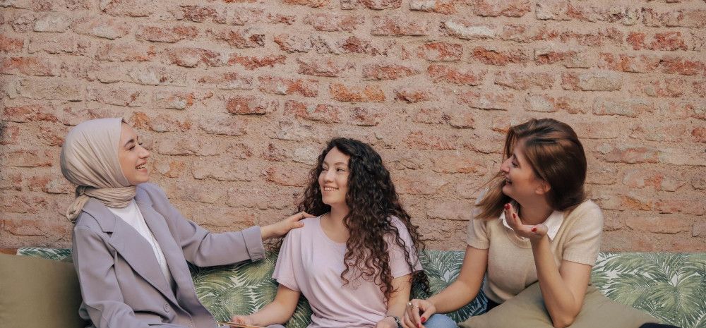 Three ladies are chatting and having fun