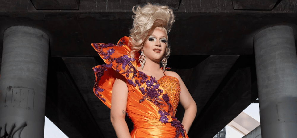 A drag queen wearing an orange dress.
