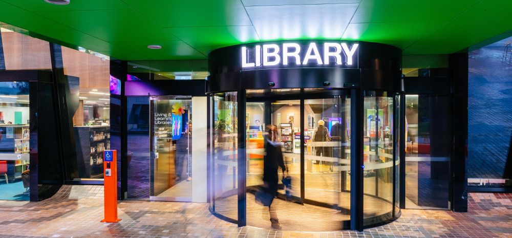 Front door of Dandenong Library. The word Library appears above the door.