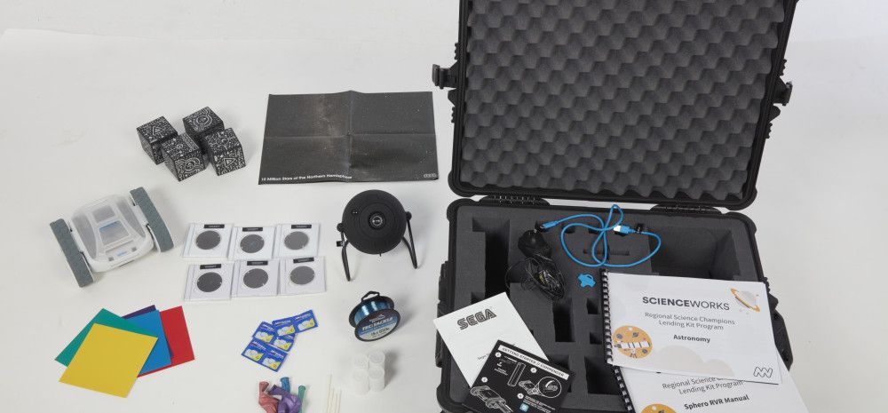 An open astronomy kit with contents beside it