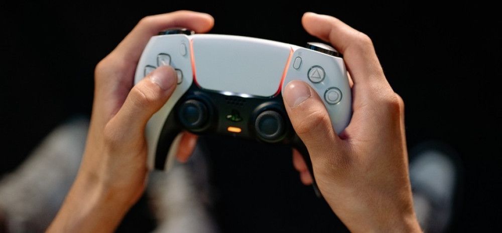 Games controller with hands on the controls.