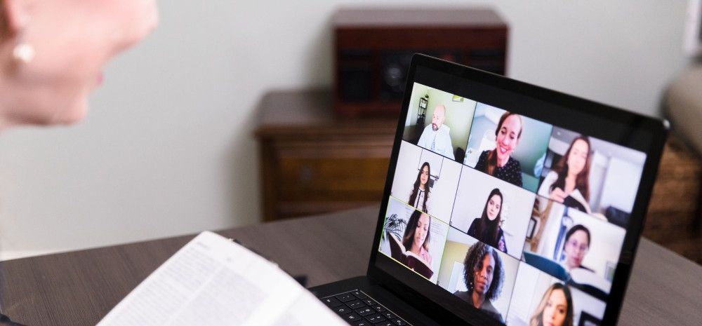 Person reading to nine person online call. 