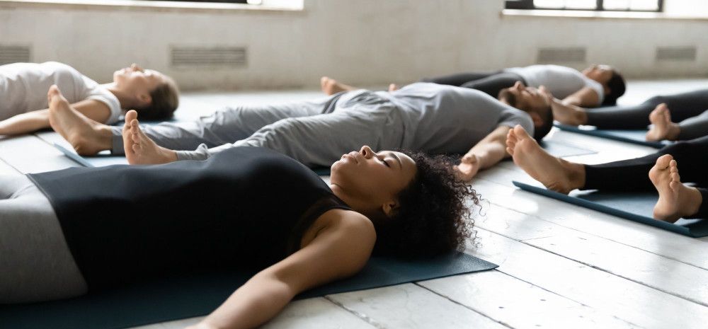 People lying on the floor for Yoga.