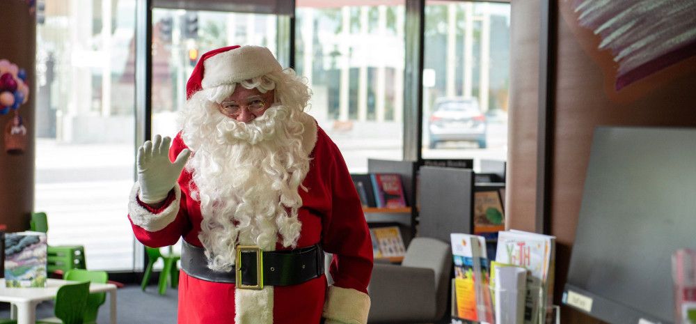 Santa waving in children's area of Dandenong Library