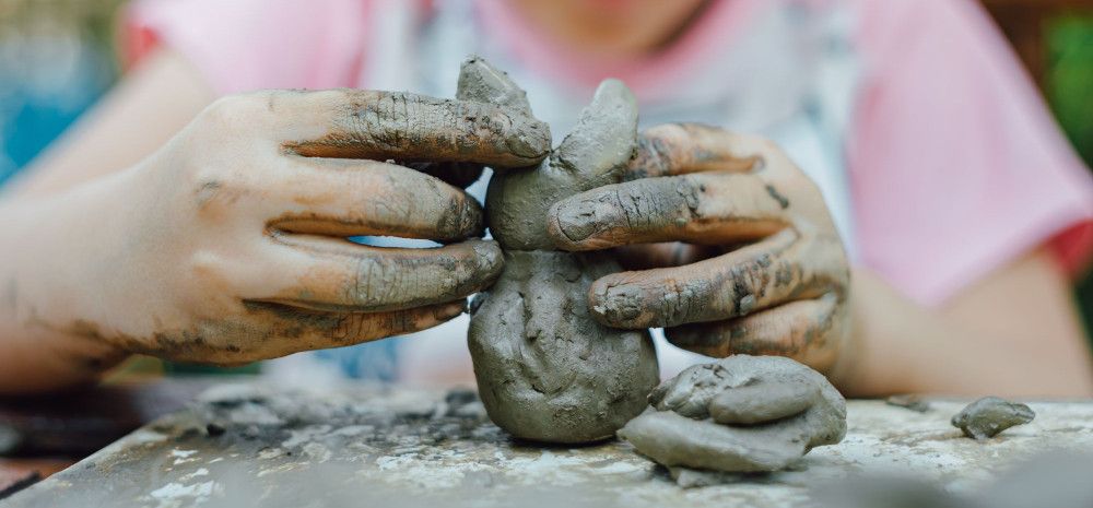 Child sculpting with clay.