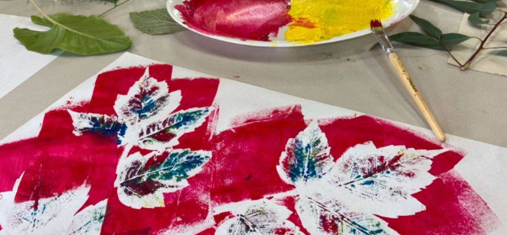 Painting colourful leaves on a white sheet. of paper