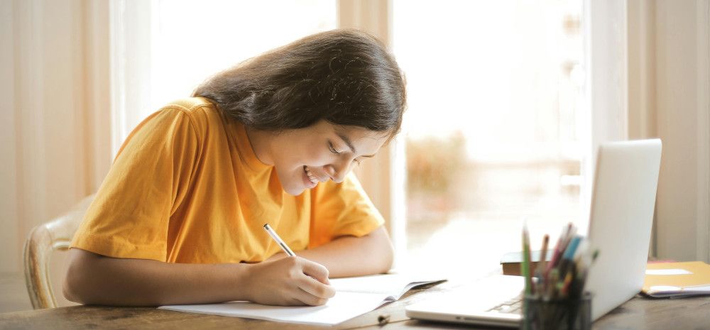 A girl sitting at a desk studying.