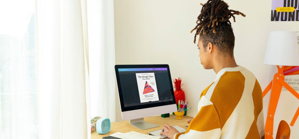 Person sitting at a desk using a computer.