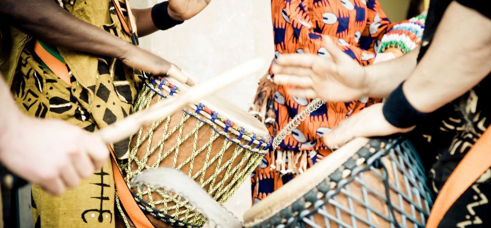 Four people drumming.