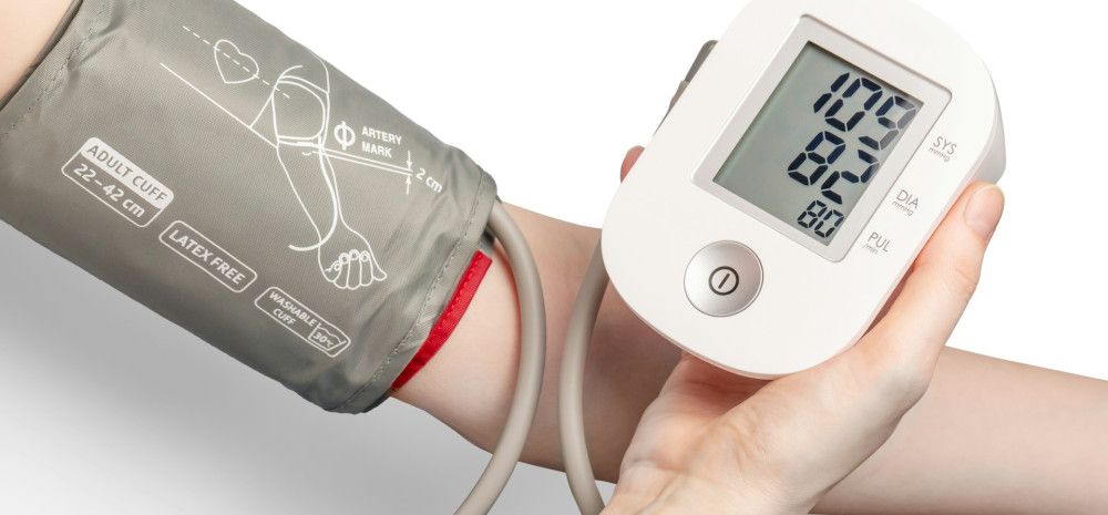 A person using a blood pressure monitor.