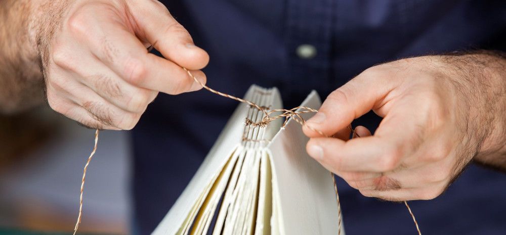 Person sewing a book block.