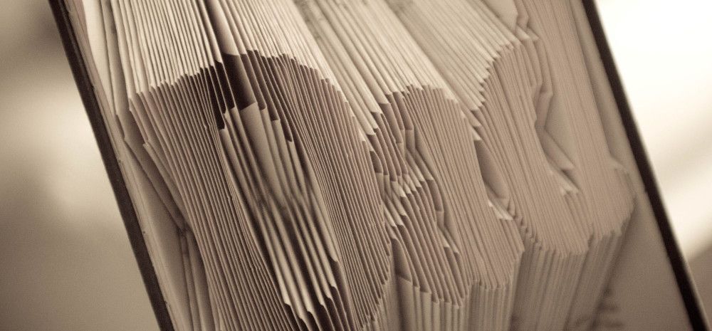 Book pages folded into art.