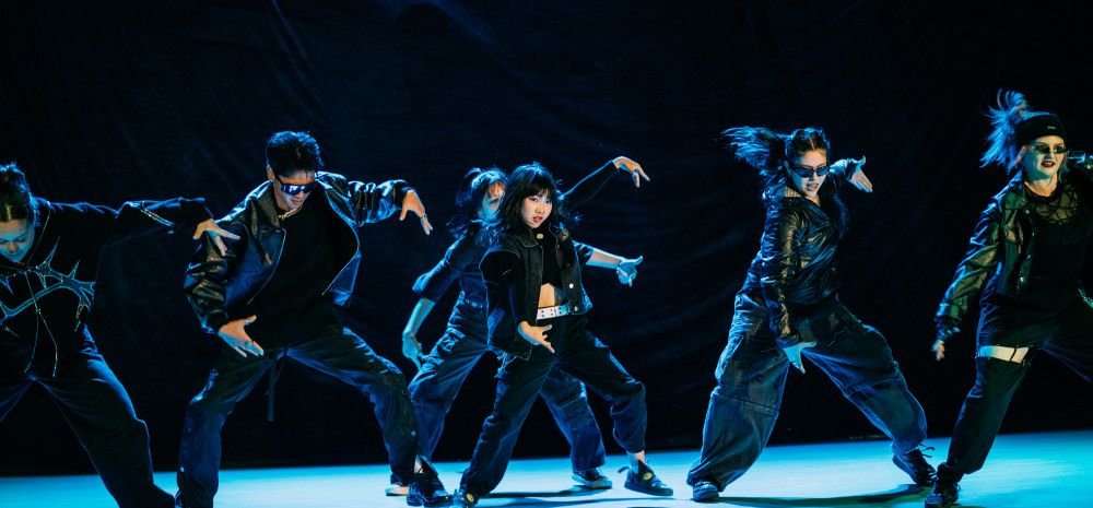 K-Pop dancers on stage.
