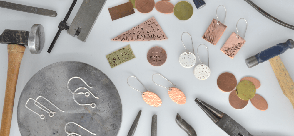Silver smithing tools and assorted earrings.