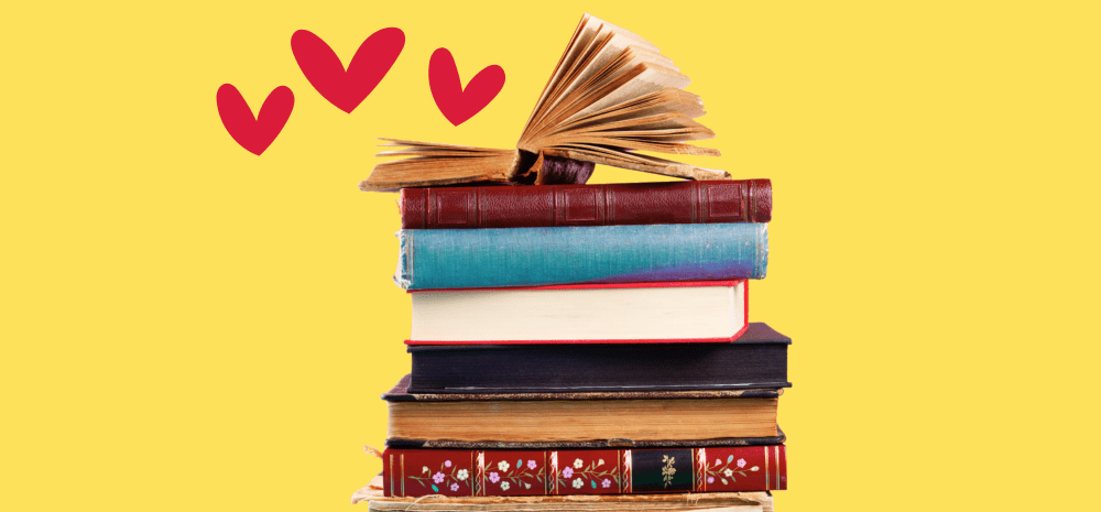 Colourful books piled against yellow background surrounded by red love hearts.