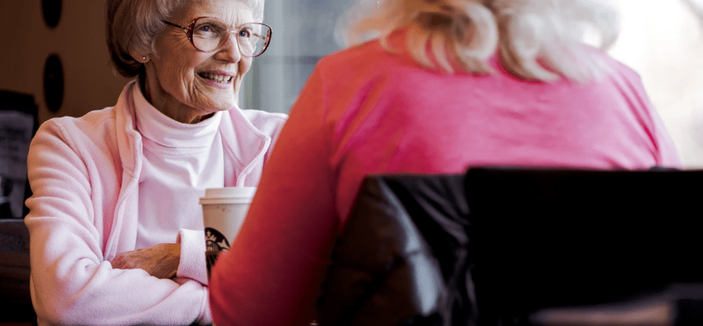 Two women chatting over a cup of coffe.