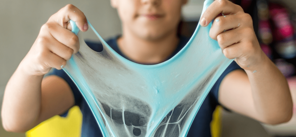 child holding up slime.