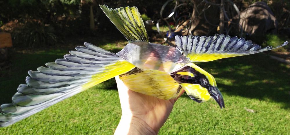 Bird puppet being held aloft.