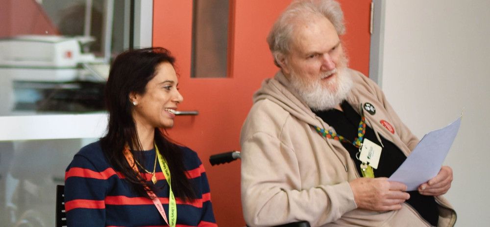 Staff member and library member talking in the library.