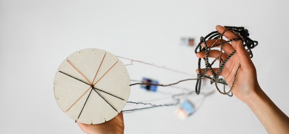 Kumihimo disk with various coloured threads.