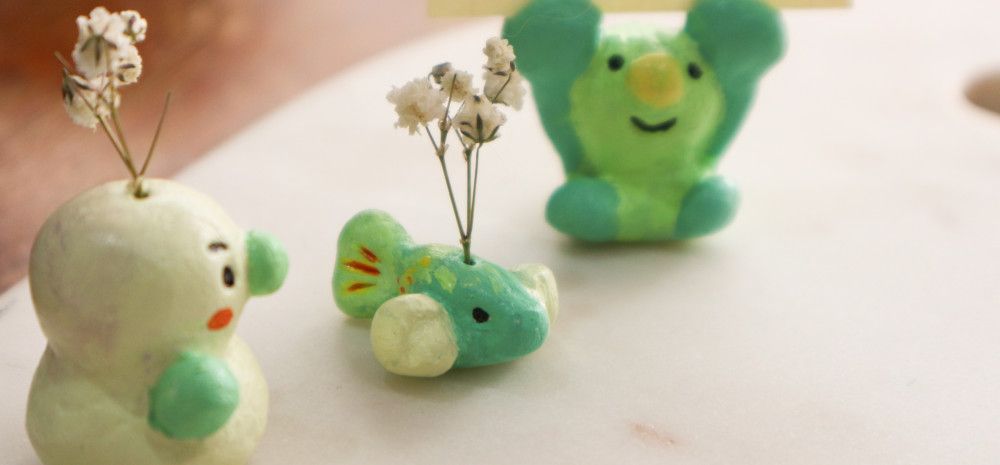 Images of air clay toys, with couple of flower branch on top