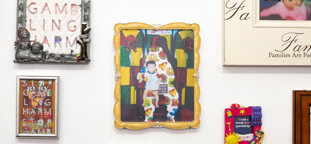 Variety of uniquely photo framed pictures on a wall.